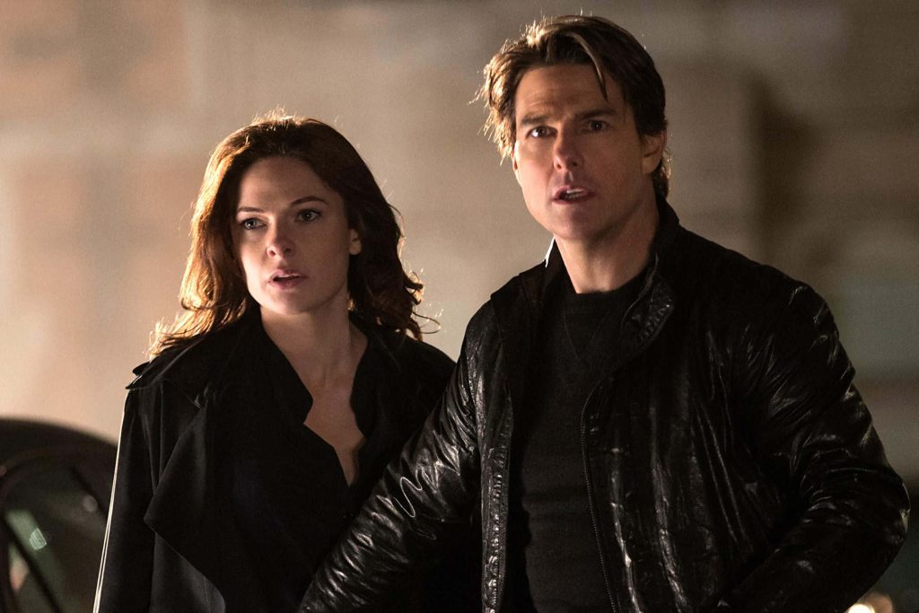 Tom Cruise and Rebecca Ferguson in dark attire share a dramatic cinematic moment wallpaper