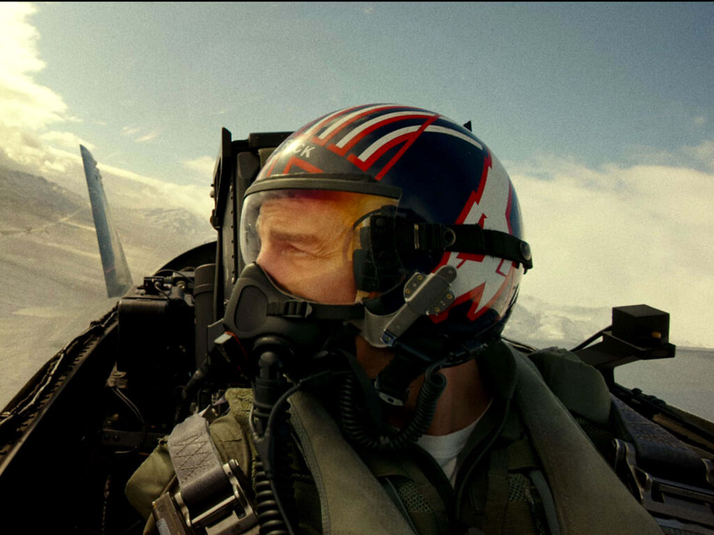 Tom Cruise as Pete Mitchell in fighter jet cockpit wearing aviator gear helmet Top Gun Maverick Wallpaper