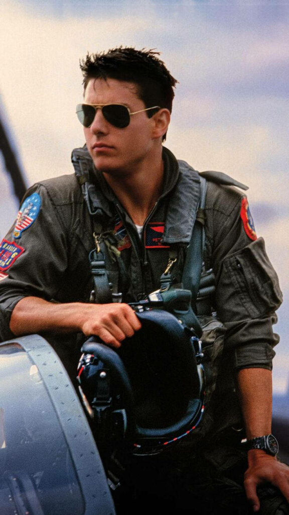 Tom Cruise as Pete Mitchell in Top Gun Maverick flight suit and aviator sunglasses wallpaper