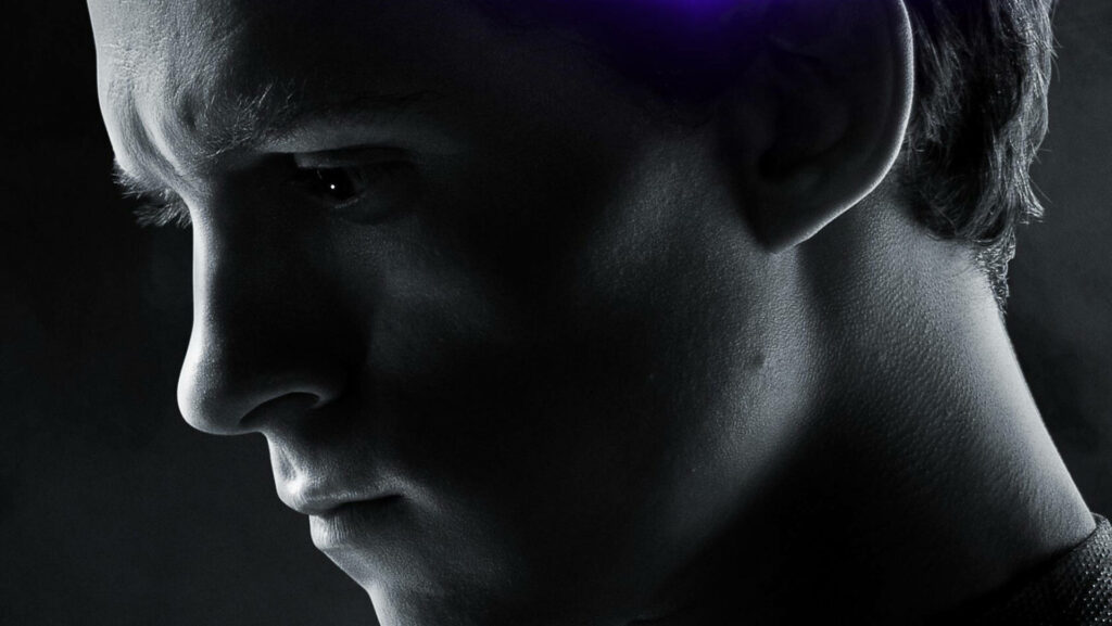 Dark greyscale close-up side profile of Tom Holland with dramatic lighting wallpaper background