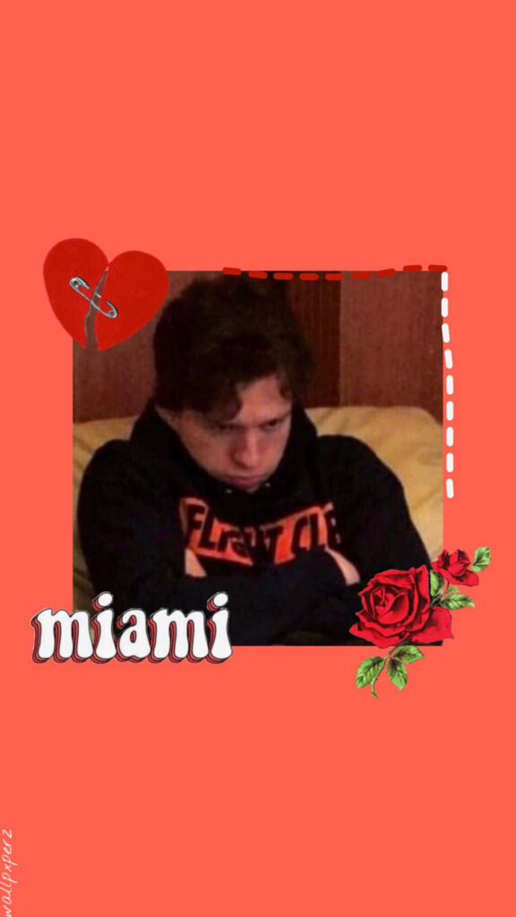 Tom Holland playful grumpy expression coral background red heart Miami red roses wallpaper