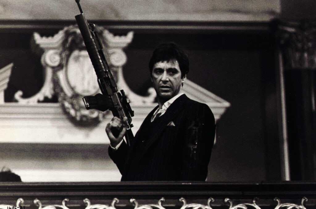 Tony Montana holding machine gun iconic Scarface intense dramatic movie wallpaper background