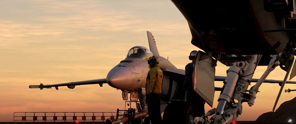 Tom Cruise as Pete Mitchell with fighter jet on aircraft carrier at sunset Top Gun Maverick wallpaper