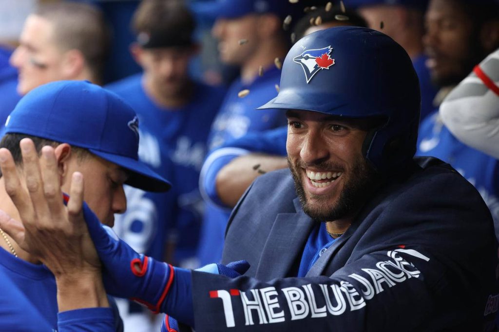 George Springer celebrating with teammate in Toronto Blue Jays helmet authentic MLB action wallpaper