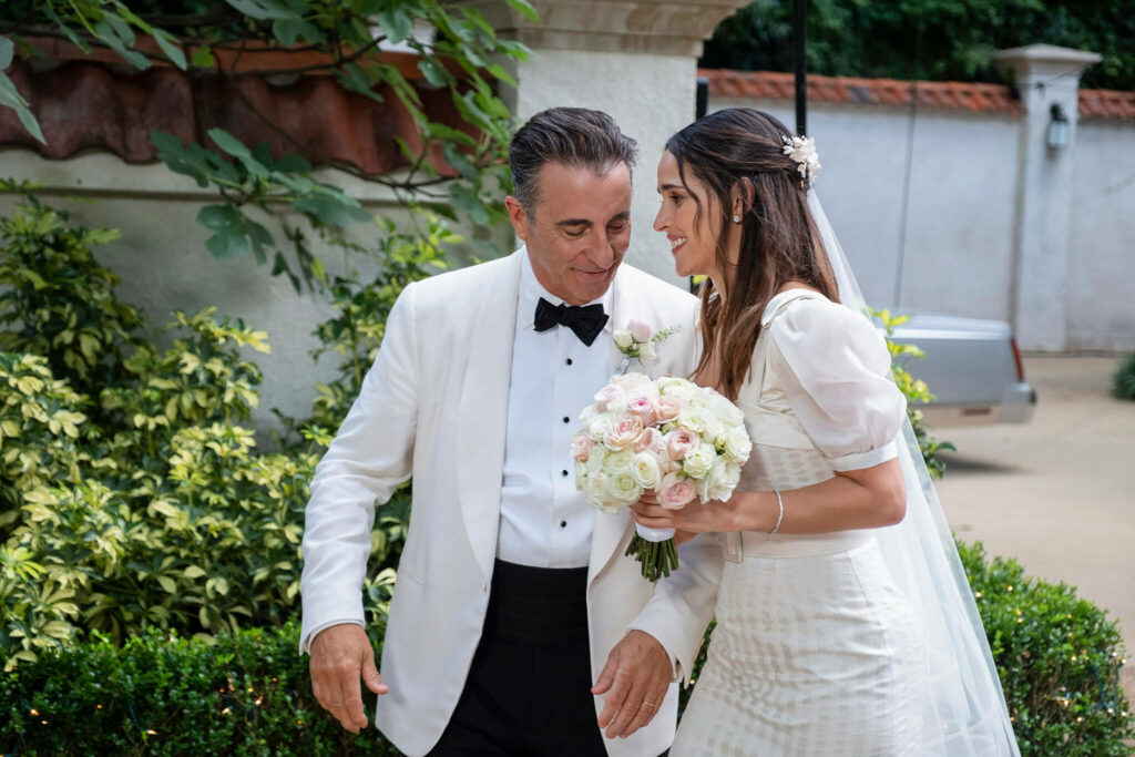 Father and bride share tender anxious joyful moment before wedding surrounded by lush greenery wallpaper