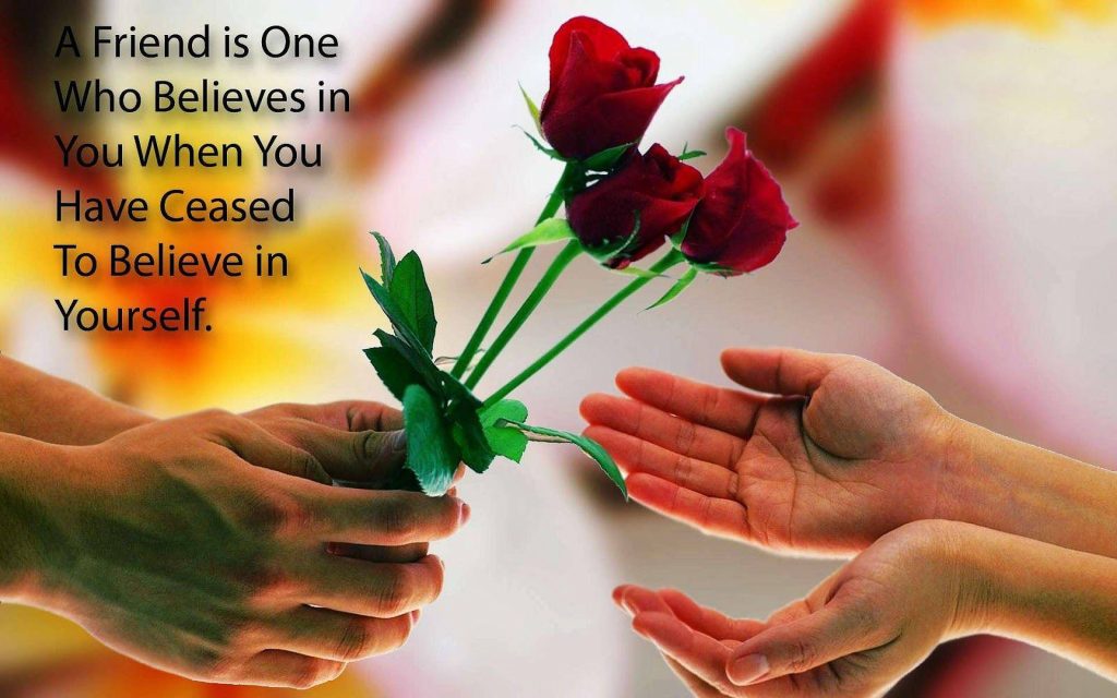 Hands offering red roses with friendship quote about belief and support wallpaper background