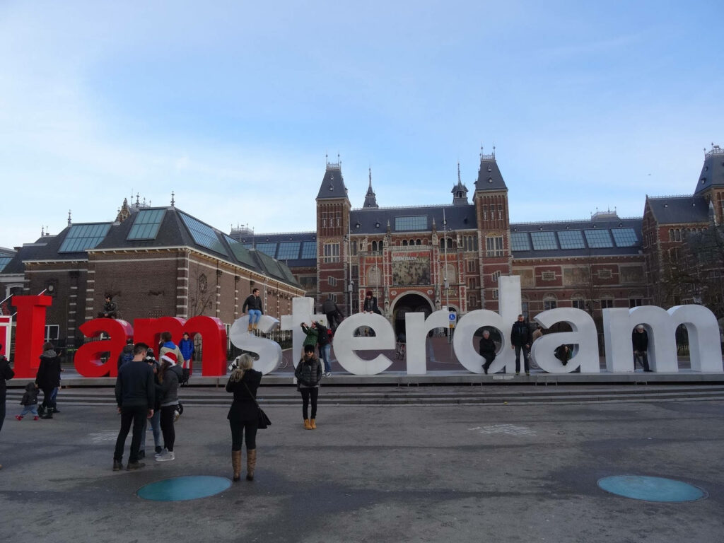 Tourists Capture Moments at I Amsterdam Sign by Rijksmuseum - Wallpaper