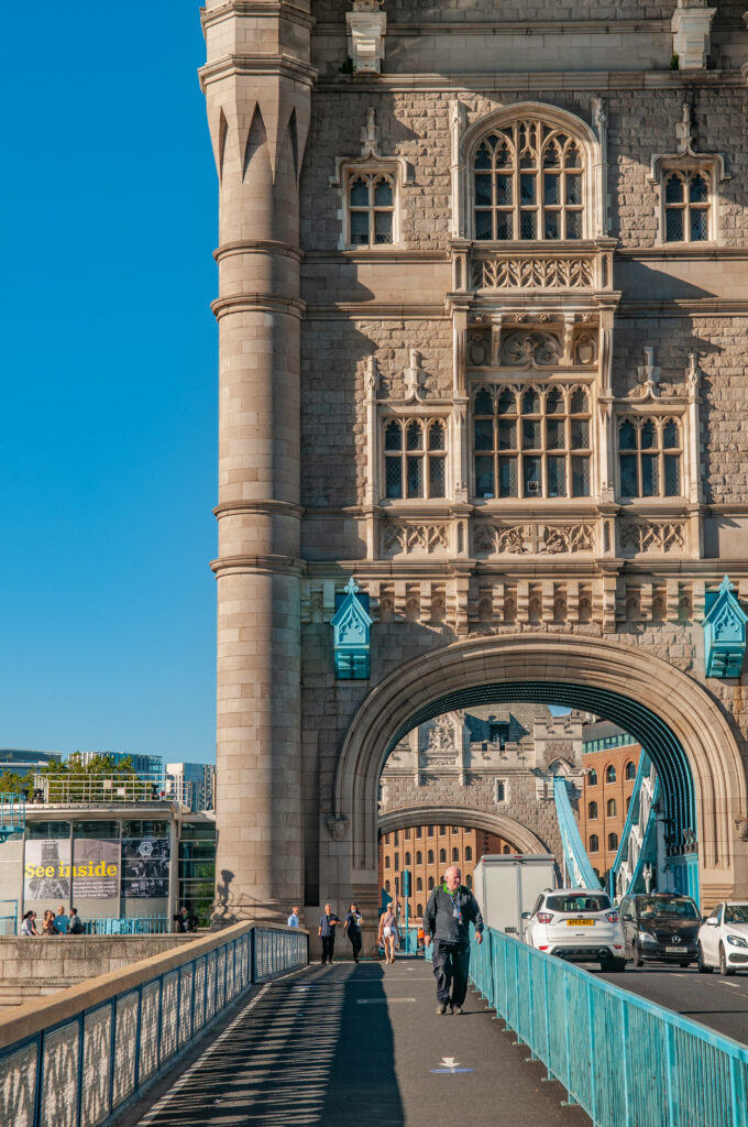 Stunning Tower Bridge Sidewalk Wallpaper Background Under Blue Sky