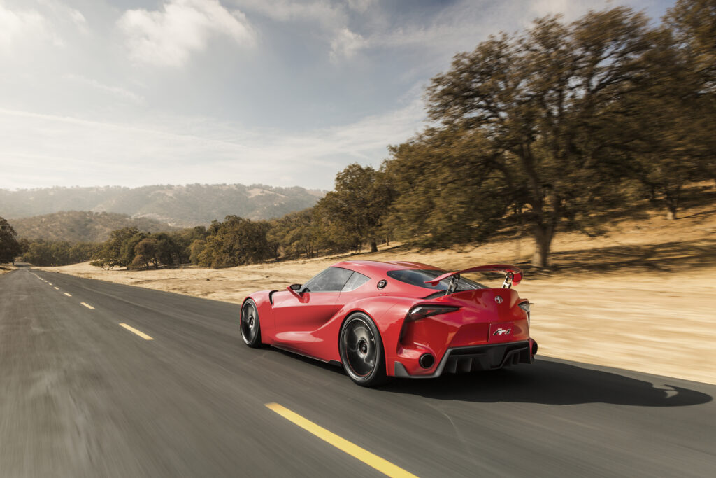Sleek Toyota FT-1 Concept Car Wallpaper: Futuristic Open Road Scene