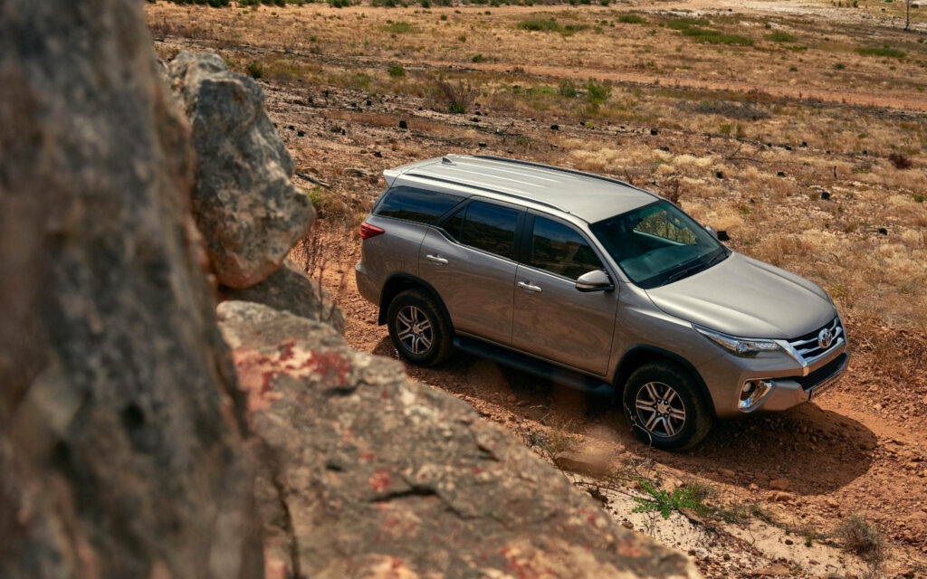 Toyota Fortuner Avant-Garde Bronze navigating rocky terrain showcasing bold off-road design Wallpaper
