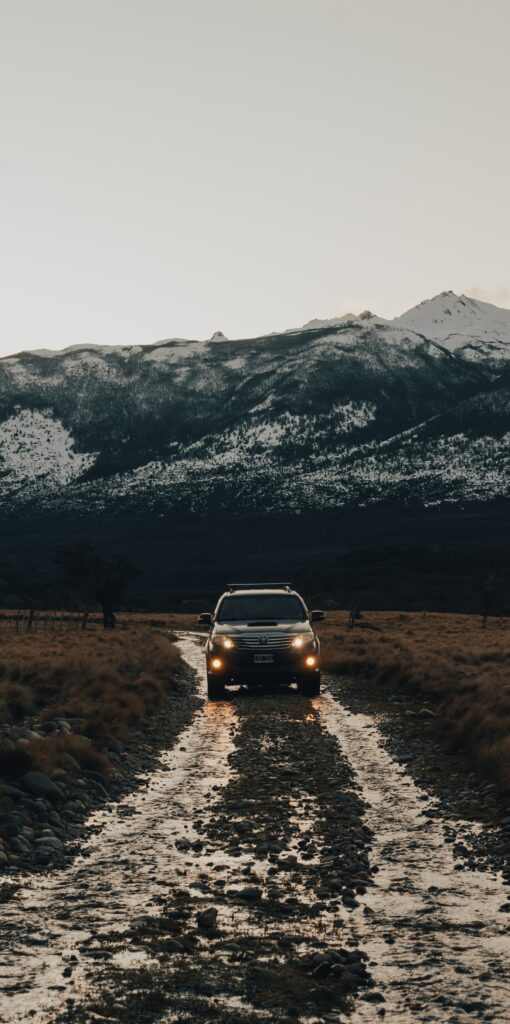Adventure Awaits: Rugged Toyota SUV on Mountain Road Wallpaper