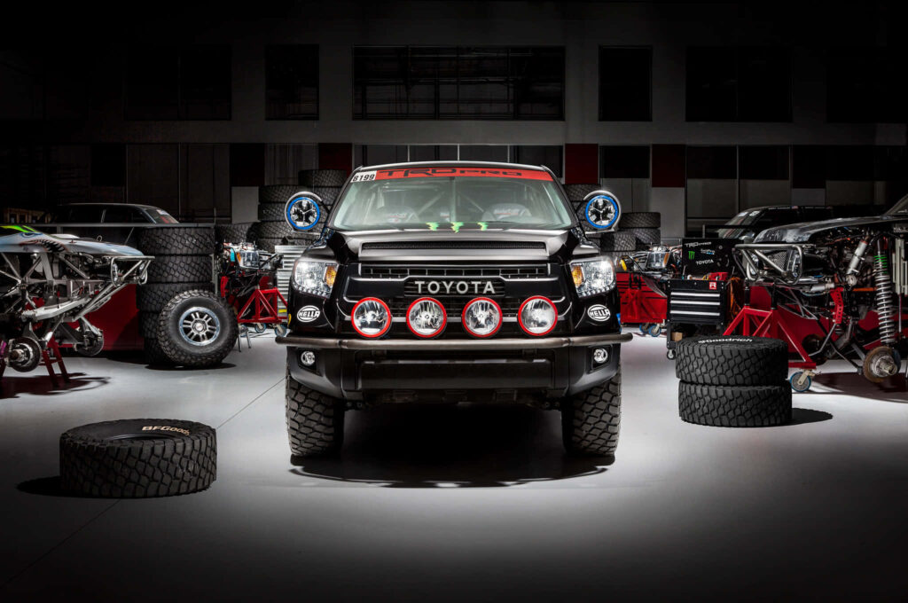 Toyota TRD Pro Tundra in garage with bold grille off-road lights racing tires wallpaper background