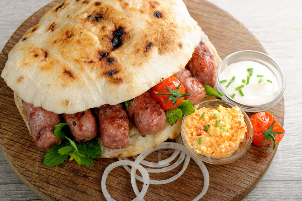 Rustic Cevapi Burger Wallpaper: Savory Flatbread & Fresh Ingredients