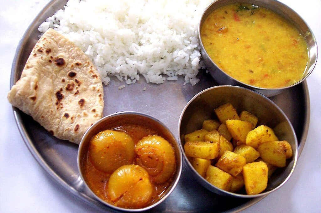 Traditional Indian Thali Meal: Roti, Rice, Curry & Potatoes Wallpaper
