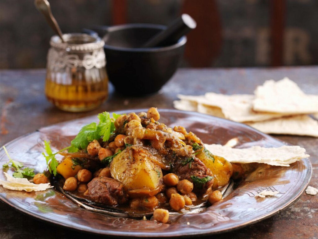 Rustic Tajine Dinner Table Wallpaper with Meats, Chickpeas & Herbs