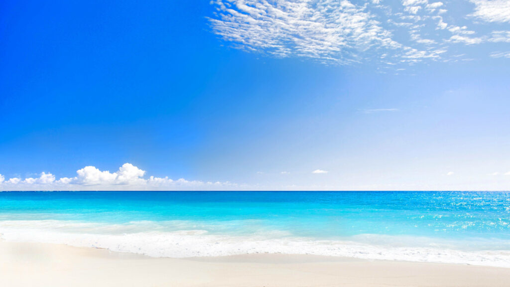 Tranquil Beach Scene 4K Wallpaper: Serene Escape with Blue Sky