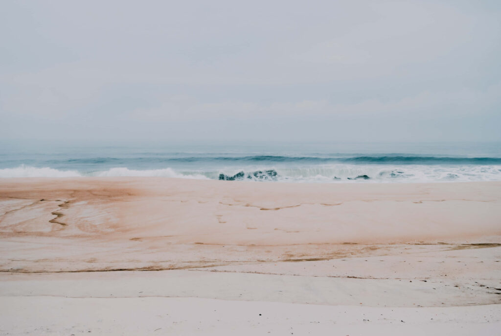 Tranquil Beach Scene Wallpaper in Soft Pastel Tones for a Soothing Background