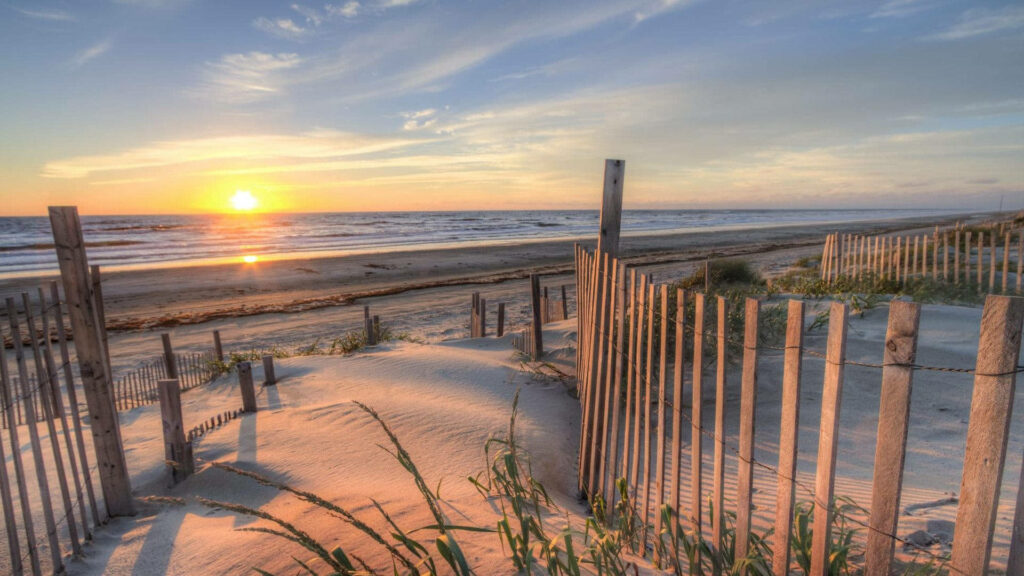 Summer Sunset Bliss: Tranquil Beach Scene with Rustic Charm Wallpaper