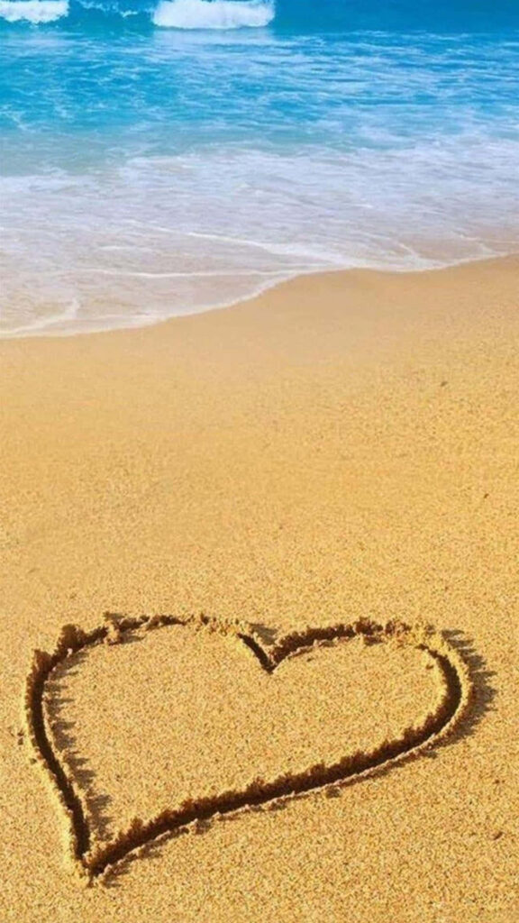 Tranquil Beach Sunset Wallpaper with Romantic Heart in Sand