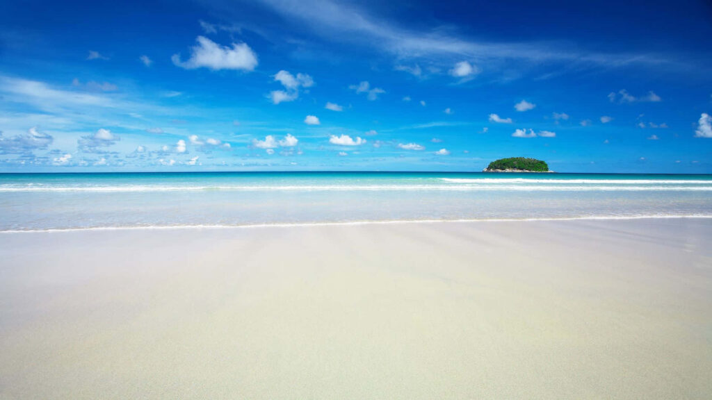 Pristine Beach Wallpaper: Tranquil Shoreline & Blue Sky Background