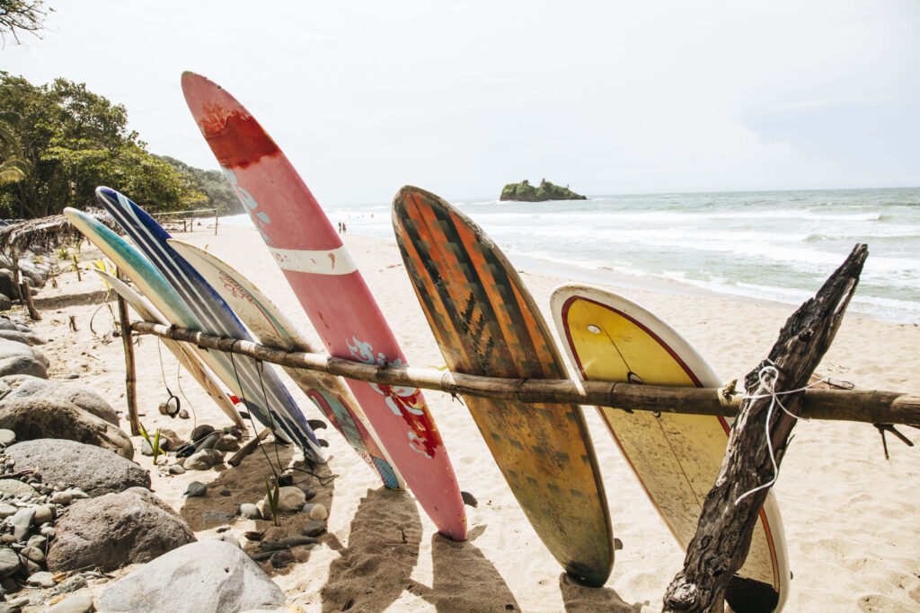 Tranquil Beach Scene with Colorful Surfboards and Gentle Waves Wallpaper