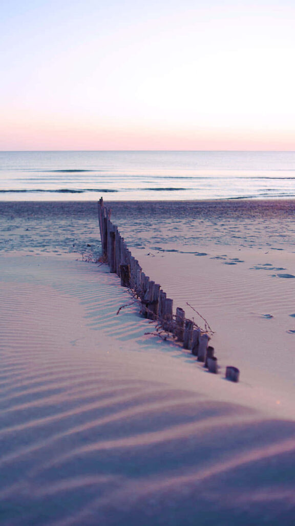 Tranquil Beach Wallpaper: Gentle Sunrise Over Calm Waters