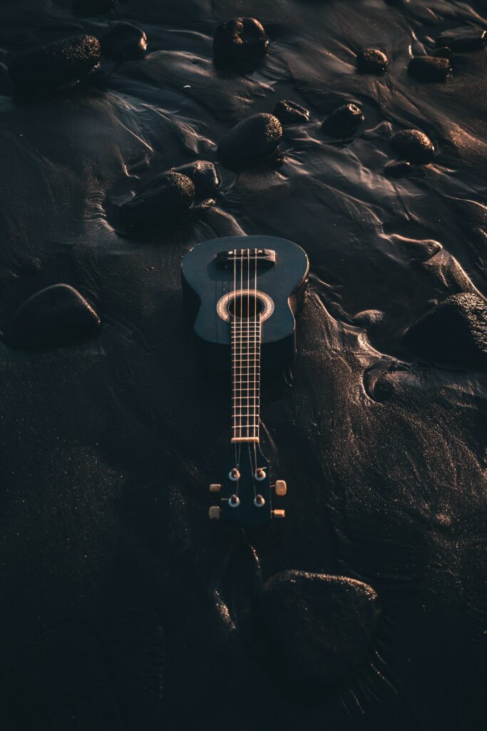 Tranquil Black Ukulele Wallpaper: Serene Beach & Nature Scene