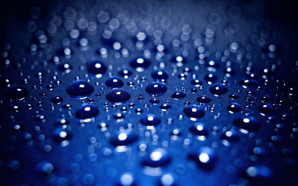 A Serene Symphony: Captivating Blue Drops Dance on QHD Wallpaper