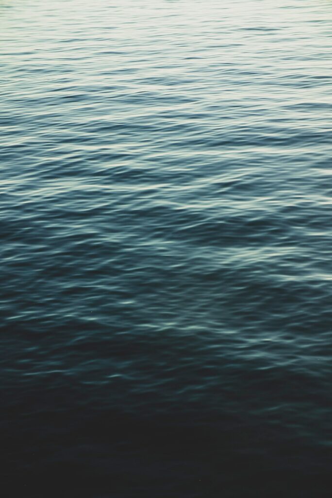 Calming sea wallpaper with gentle ripples and wavy blue green patterns for a peaceful background