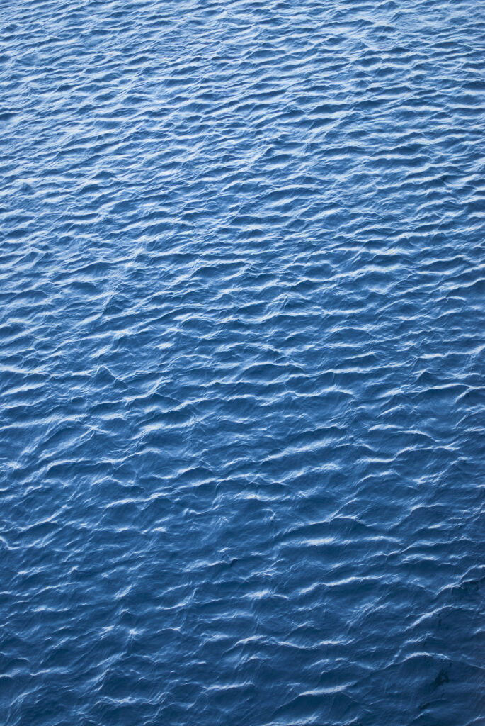 Tranquil blue sea wallpaper with gentle ripples creating a calming minimalistic ocean texture