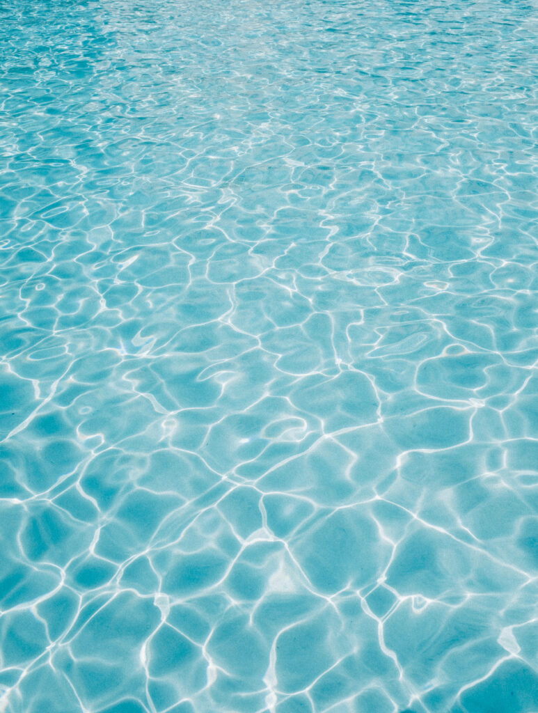 Calming Blue Pool Water Wallpaper - Serene Sunlit Ambiance