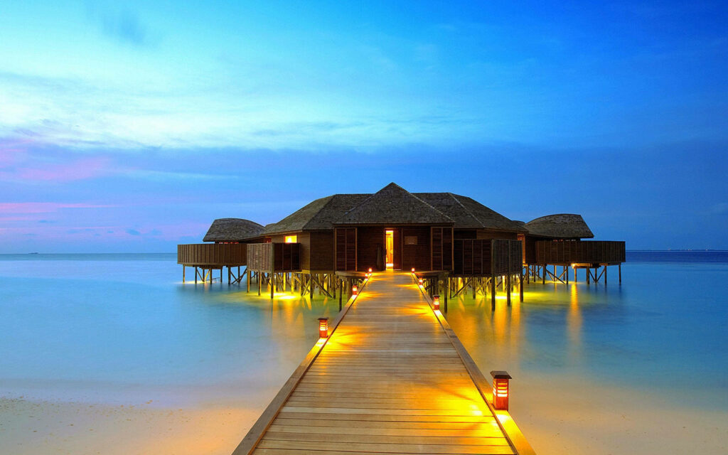Tranquil Boardwalk Over Turquoise Waters - Serene Beach Resort Wallpaper
