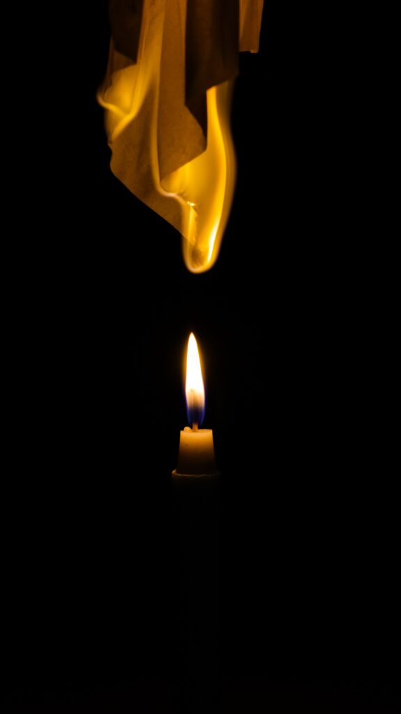 Tranquil Candle Flames: Captivating Black Background Wallpaper