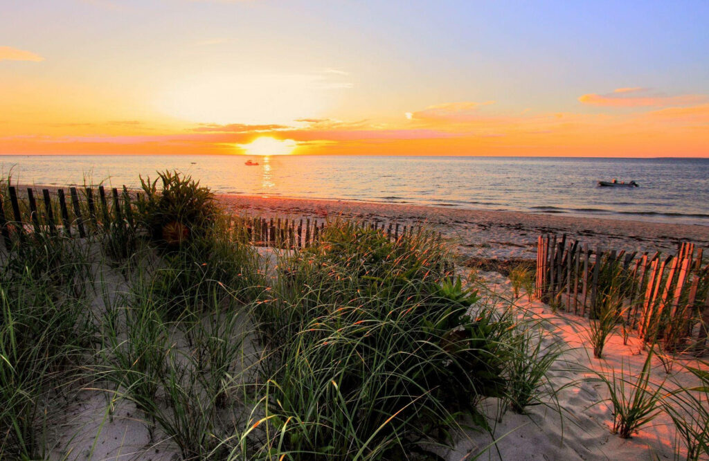 Tranquil Cape Cod Beach Sunset Wallpaper with Vibrant Ocean Hues