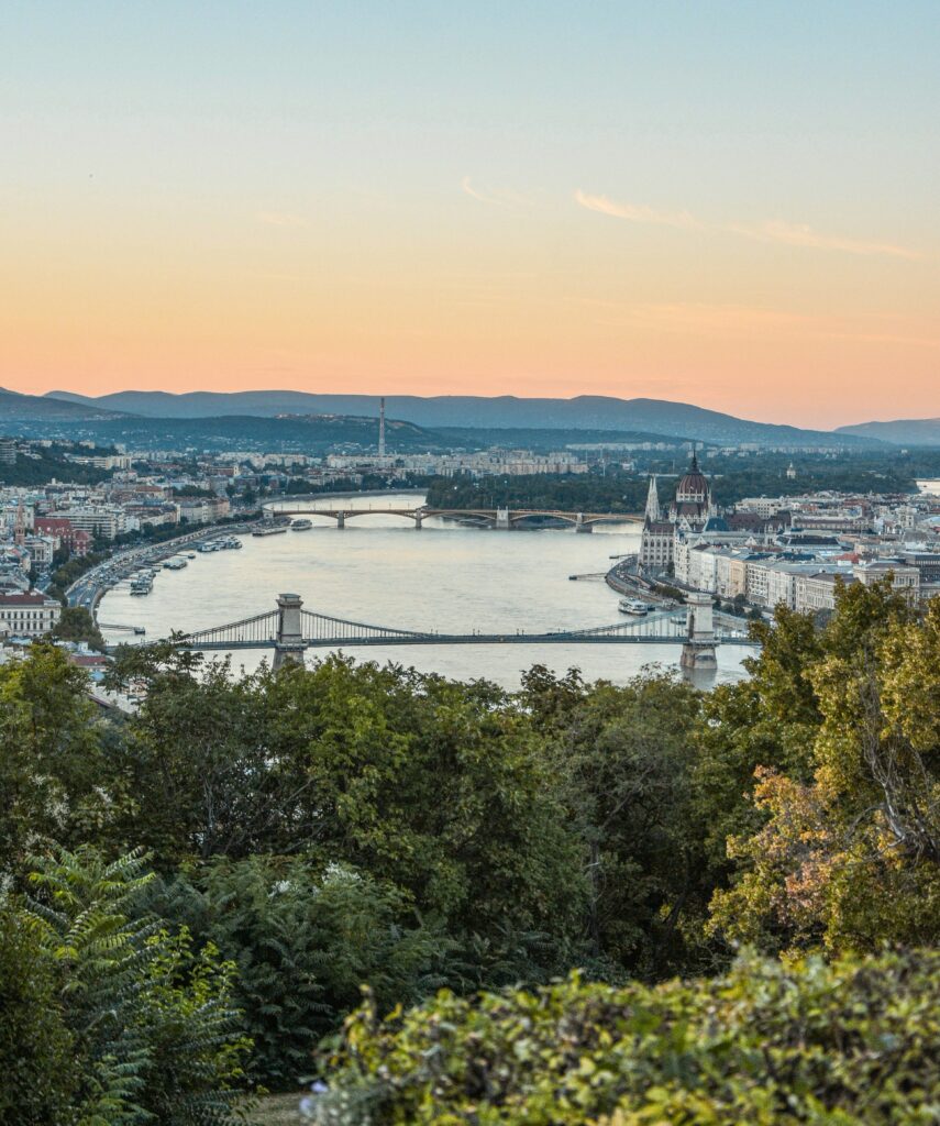 Serene Cityscape Wallpaper: River, Bridges & Sunset Ambiance