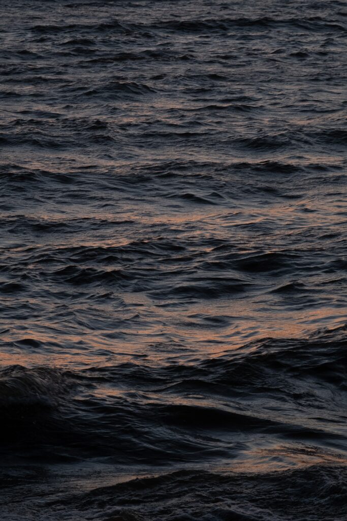 Dark ocean waves with soft highlights creating a tranquil moody wallpaper background for calming