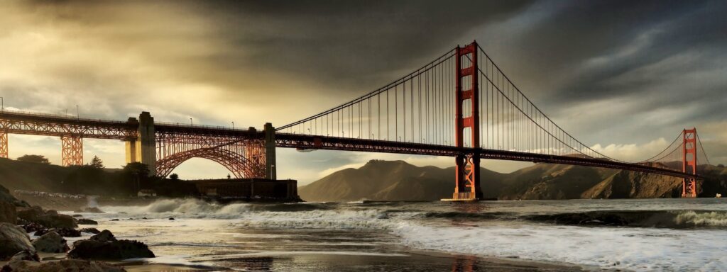 Tranquil Evening Bridge Wallpaper Over Serene Waterway & Cityscape