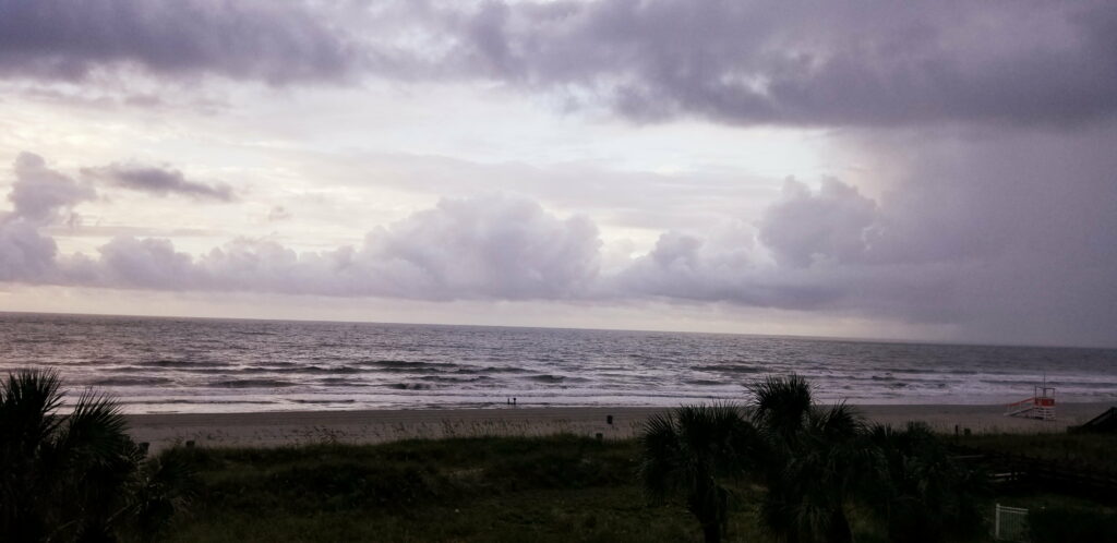 Majestic Waves: A Breathtaking Coastal Landscape on a Cloudy Beach Wallpaper