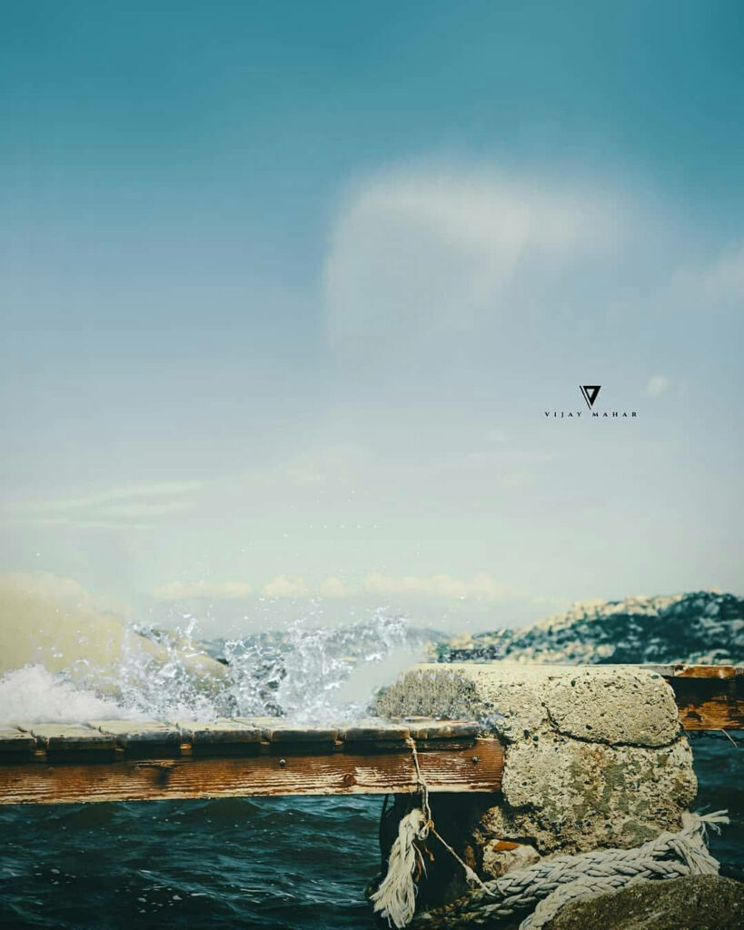 Serene Waters: Vijay Mahar photography captures a picturesque bridge surrounded by glistening blue waters under a clear sky Wallpaper