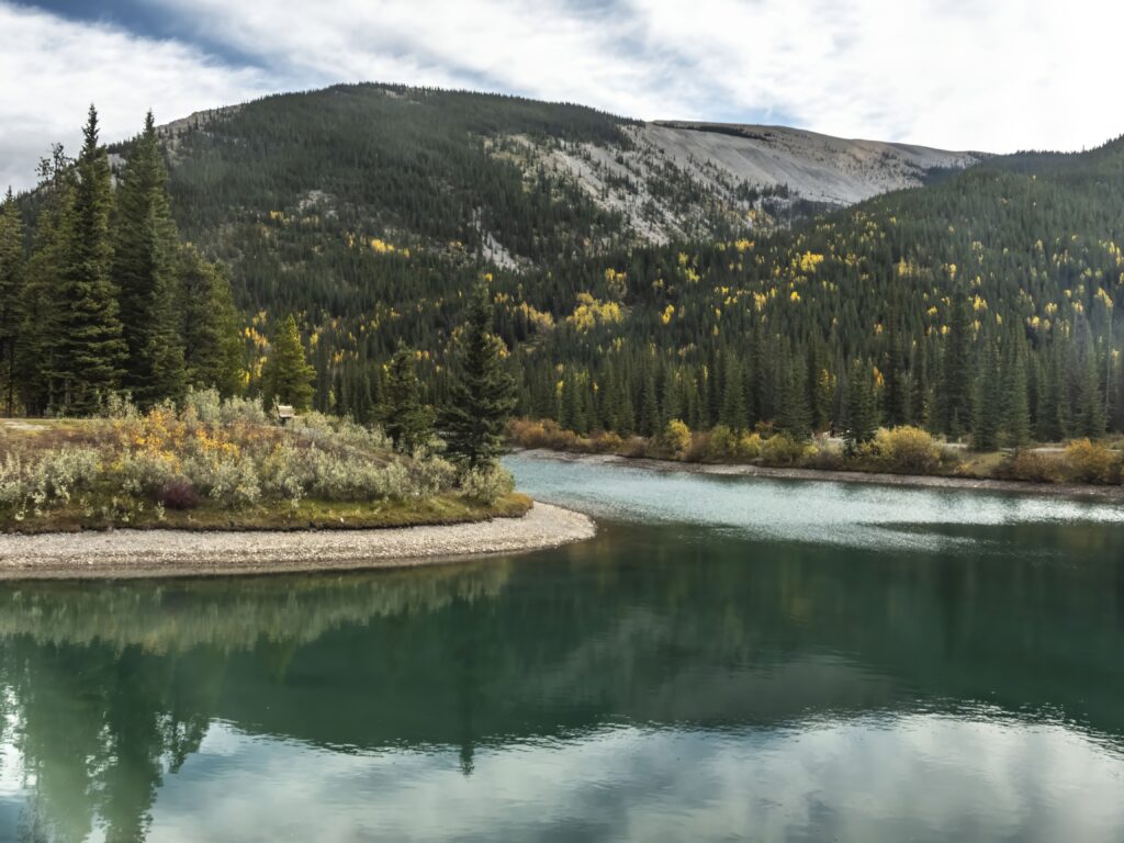 Tranquil mountain landscape wallpaper with serene lake lush forest and colorful trees reflection