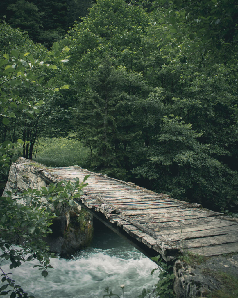 Tranquil Nature Wallpaper: Rustic Bridge Over Gentle River
