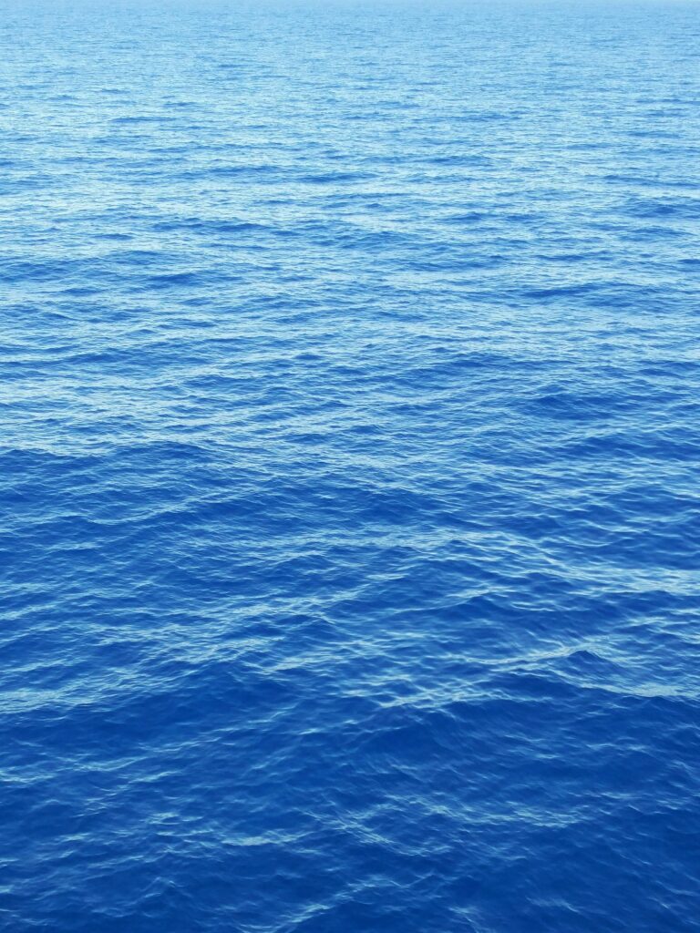 Tranquil open sea wallpaper with soft daylight rippling blue water for calm background