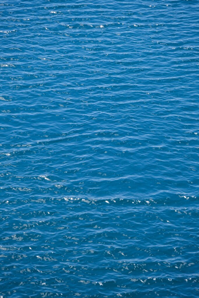 Tranquil deep blue sea wallpaper with gentle waves and delicate ripples for calming atmosphere