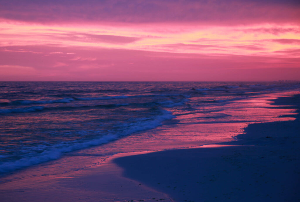 Tranquil Beach Sunset: Pink Hues Reflect on Gentle Waves Wallpaper
