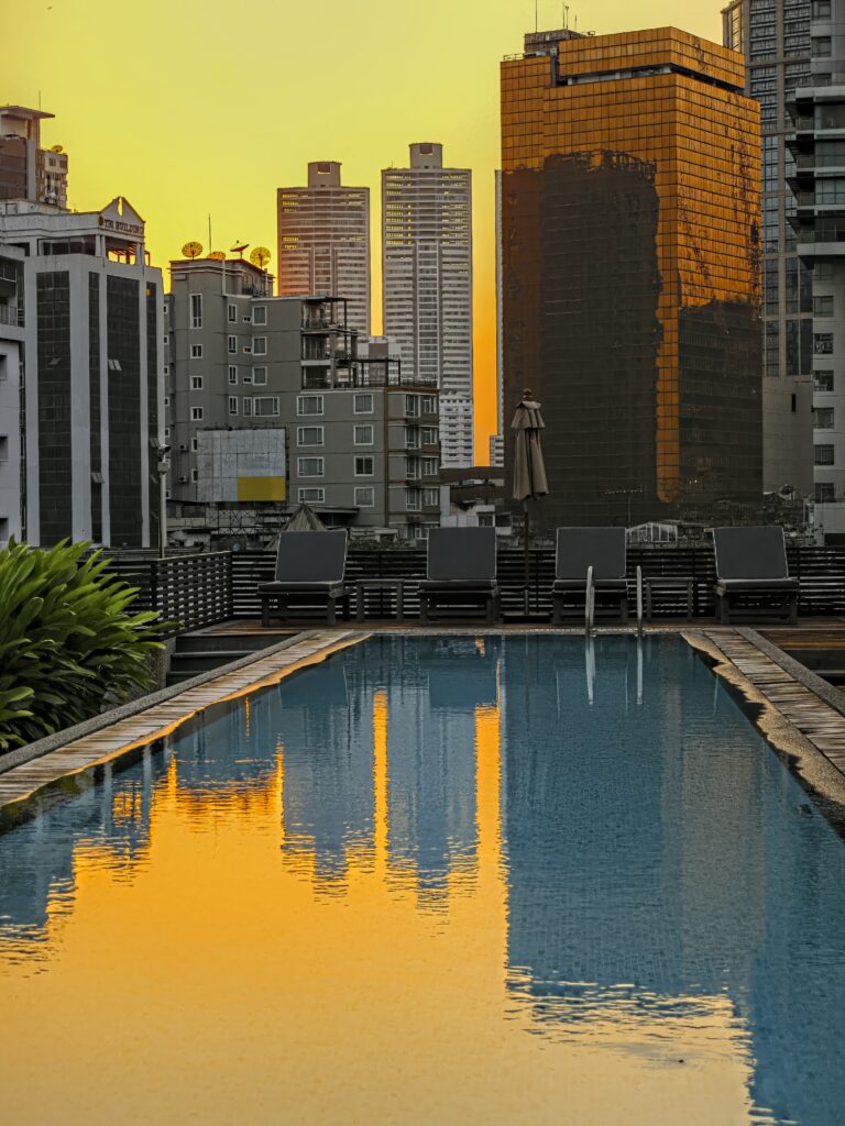Serene Urban Pool Wallpaper: Sunrise Reflections & Cityscape