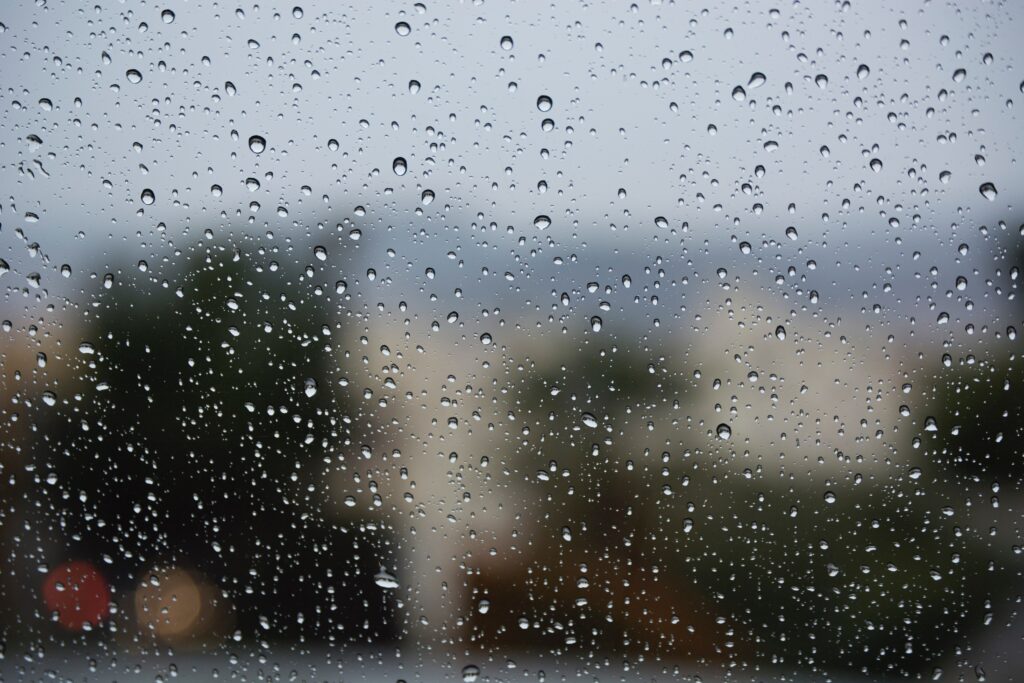 “Serene Raindrops on Glass: Tranquil Wallpaper Background”