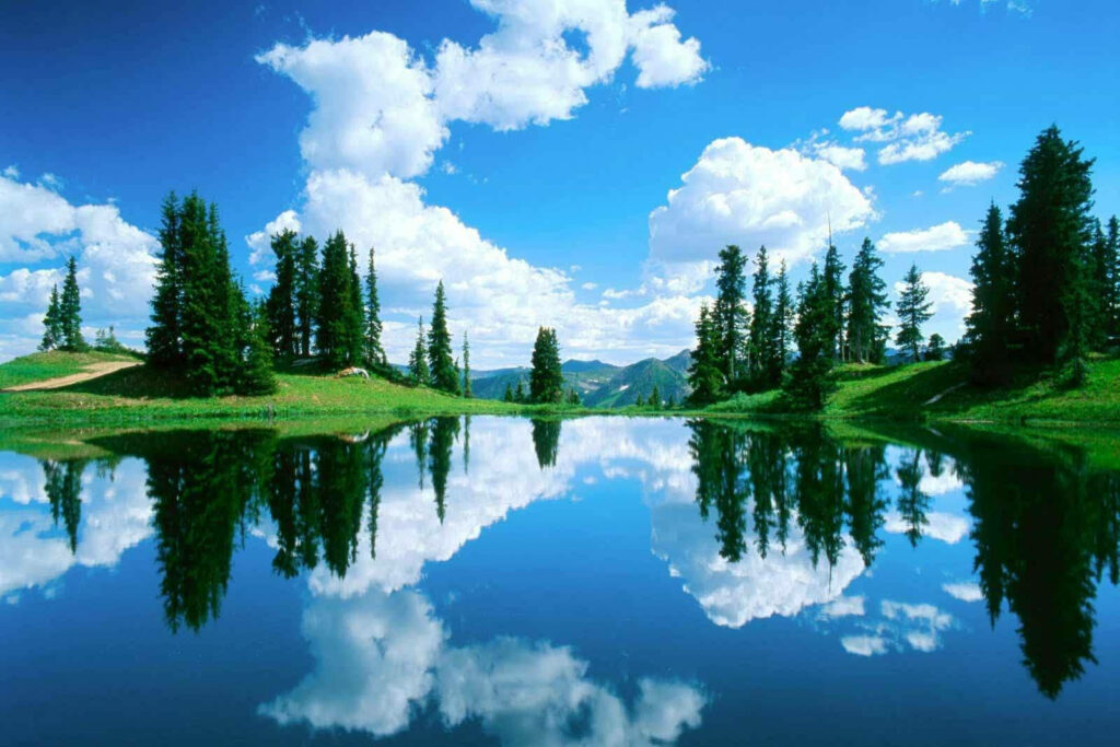 Tranquility Reflected: Captivating HD Background Image of a Peaceful Lake Embracing the Azure Sky Wallpaper