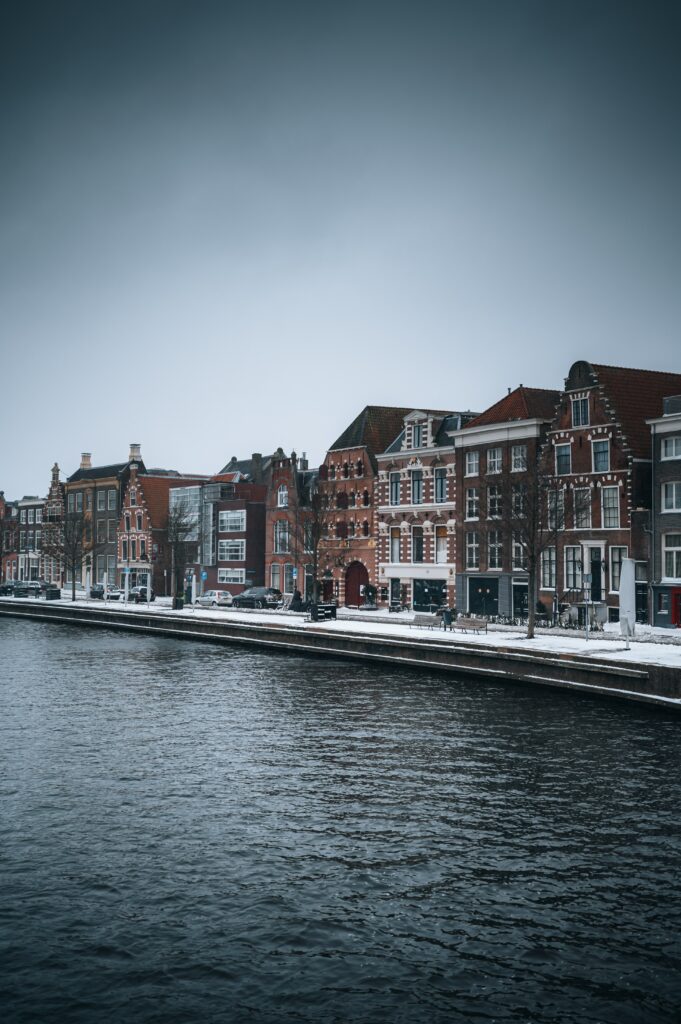 Tranquil Riverside Cityscape Wallpaper: Classic Architecture Reflection