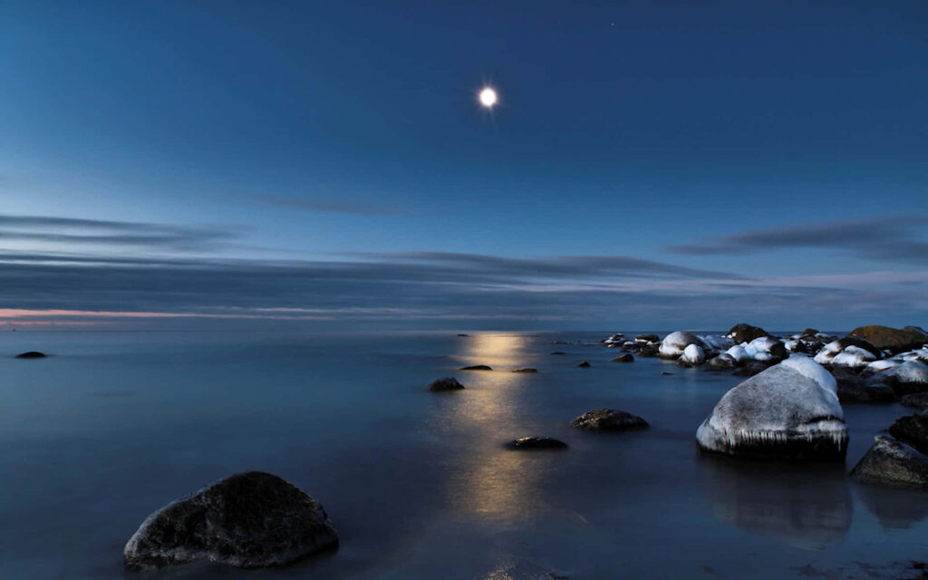Tranquil Starry Night Sky Wallpaper with Moonlit Waters
