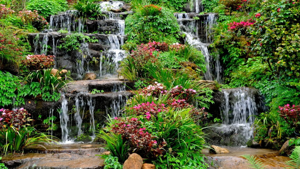 Summer Bliss amidst Enchanting Waterfall Cascades in Bonito Park: A Vibrant Oasis of Wildflowers Wallpaper
